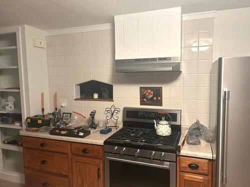 kitchen tile wall and Briwax oak cabinets after renovation